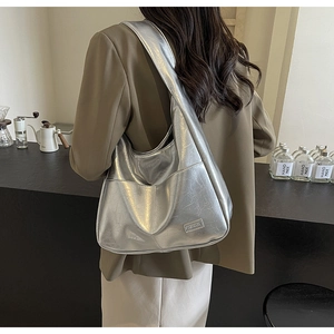 Silver metallic shoulder bag with crackle texture showing a stylish fashion metal logo