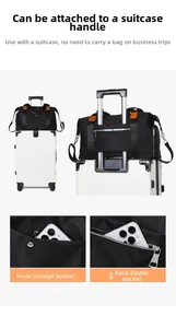 Detail of the luggage sleeve on a black oxford fabric travel tote bag on white background