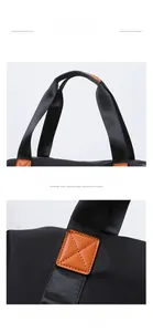 Detail of durable Oxford travel bag handle with orange leather pads and reinforced stitching