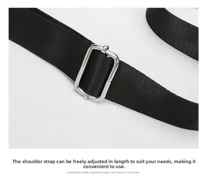 Detail of adjustable nylon strap with polished silver metal buckle for versatile bag length