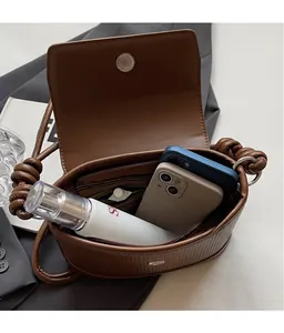 Brown textured PU leather crossbody bag with spacious interior for two phones and cosmetics