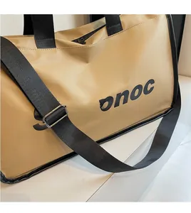 Close-up of the adjustable black shoulder strap and silver buckles on a khaki travel bag