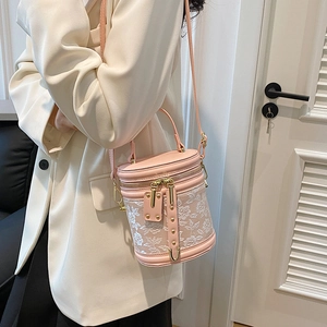 Elegant pink bucket bag with floral lace embroidery and gold metal details