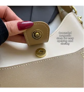 Detailed macro view of the gold magnetic closure on a two-tone bucket handbag