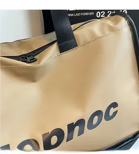 Detail of khaki fitness bag with waterproof texture and bold black letter printing