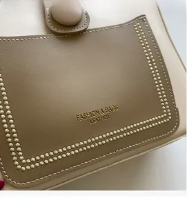 Detail of two-tone bucket bag with double stitching and Fashion & Bags Leather text