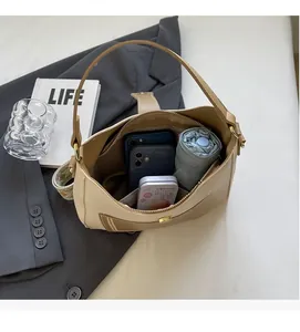 Top view of beige hobo bag interior showing large capacity for phone and umbrella