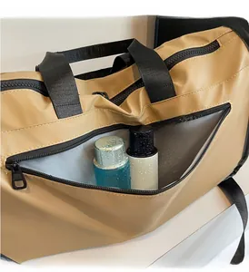 Detail view of the khaki fitness bag showing the waterproof wet and dry separation compartment