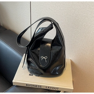 Minimalist black PU leather crossbody bag with glossy finish and silver bow detail