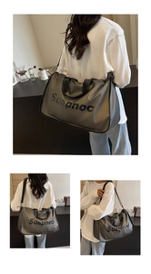 Detail view of large gray waterproof fitness travel bag with adjustable strap and side logo