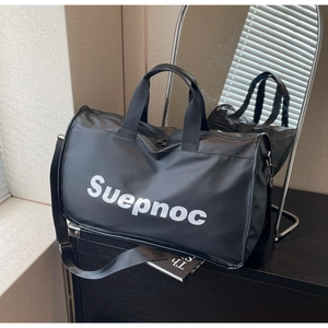 Detail of waterproof nylon travel bag featuring Suepnoc lettering and durable handles
