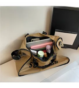 Top view of large khaki travel bag showing spacious interior with laptop and accessories