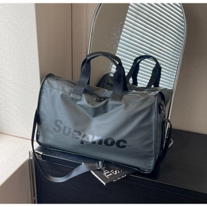 Detail of dark grey travel bag with Suepnoc print, reinforced handles and shoulder strap