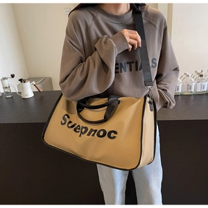 Detail of large travel tote bag with black strap and Suepnoc print on khaki canvas