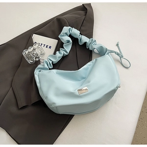 Light blue ruched PU leather crossbody bag with silver buckle on grey blazer