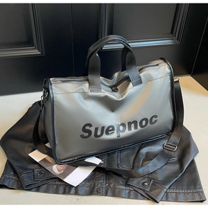 Close-up of waterproof silver travel bag with Suepnoc logo on a black leather jacket