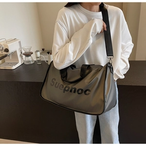Detail of dark grey waterproof gym bag with black handles and Suepnoc branding