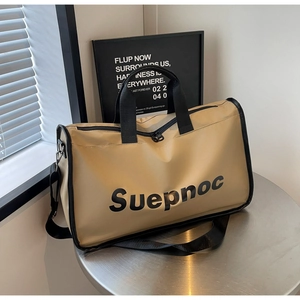 Detail of khaki fitness bag with Suepnoc print on metal table with shadows