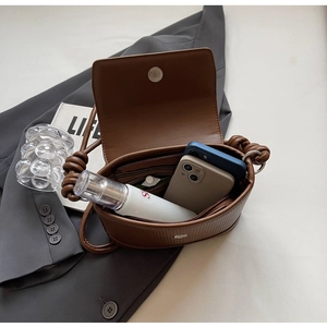 Interior view of brown pleated crossbody bag showing phone storage and zip pocket