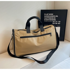 Detailed macro view of khaki travel bag with nylon texture and black woven handles