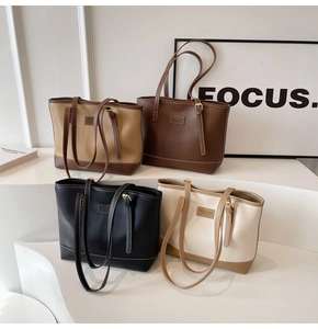 Macro detail of high-quality faux leather texture and white contrast stitching on tote bag