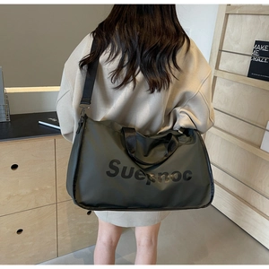 Detail view of large nylon travel tote bag with adjustable strap and Suepnoc lettering