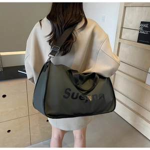 Macro detail of dark green travel bag with adjustable strap and Suepree logo