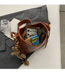 Top view of spacious interior of brown vintage bucket bag showing large capacity and bear charm