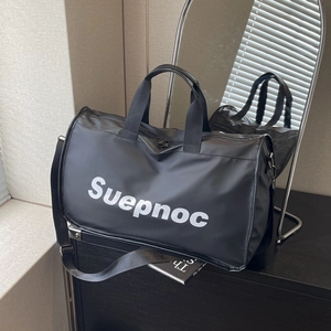 Large black fitness travel bag with Suepnoc logo on a sleek wooden table