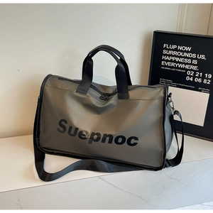 Close-up of grey-green large capacity travel bag with durable black handles and logo