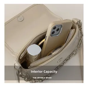 Internal capacity of cream crossbody bag showing space for phone and cosmetics