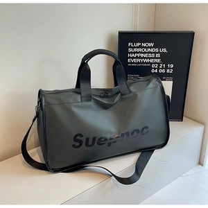 Detail of olive green waterproof travel bag featuring Suepnoc logo and sturdy handles