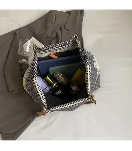 Macro shot of spacious woven tote bag showing internal storage for tablets and daily items