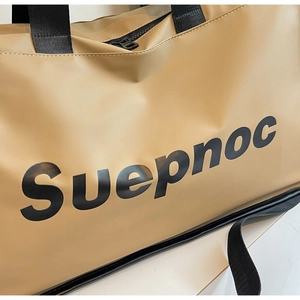 Detail of khaki travel bag showing waterproof nylon fabric and Suepnoc print