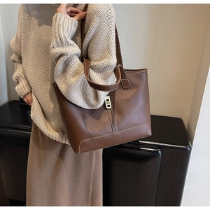 Brown leather tote bag featuring contrast stitching and versatile double shoulder straps
