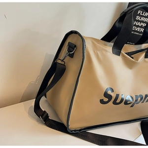 Detail of khaki travel bag showing adjustable shoulder strap and metal hardware
