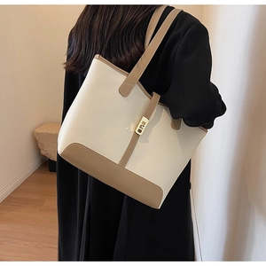 Detail of large beige and khaki tote bag with gold twist lock for daily commute