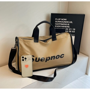 Detail view of khaki travel bag showing spacious interior with phone for size reference