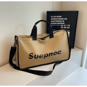 Detail of khaki large travel bag with Suepnoc logo, hand straps and shoulder belt