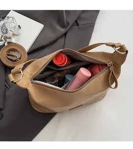 Detail view of khaki PU leather tote bag with large quilted stitching and spacious interior