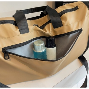 Detail of travel bag showing waterproof fabric and dry-wet separation zipper pocket