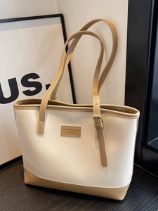 Large capacity leather tote bag in cream and tan with adjustable gold buckle detail