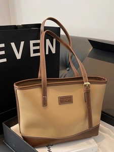Large khaki and brown contrast leather tote bag with gold buckle handles and premium texture