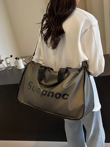 Large capacity olive green travel bag with shoulder strap worn by a female model