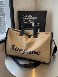 Khaki large capacity travel duffel bag with black straps on a modern metal table