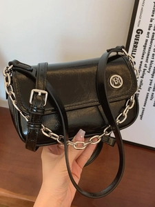 Glossy black patent leather shoulder bag with silver chain and adjustable strap