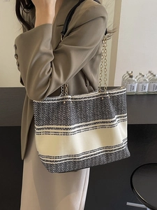 Large woven tote bag with black and white stripes and metallic chain shoulder strap