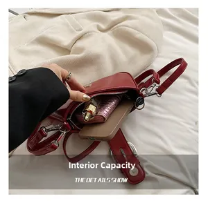Macro shot showing internal capacity with phone, wallet, and lipstick inside the red PU bag