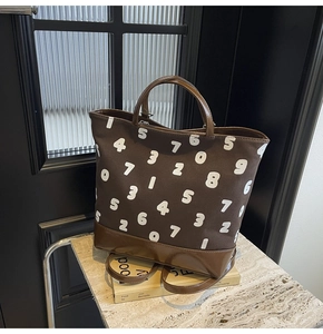 Détail d'un grand sac cabas en toile avec imprimés numériques sur une table en marbre