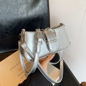 Chic silver baguette bag with metallic pleated texture and large buckle strap detail